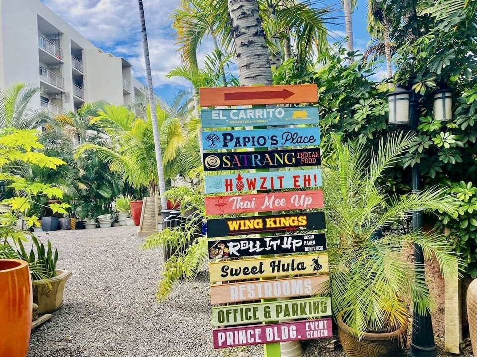 South Maui Gardens, 14 food trucks tropical setting: fountains, statues, plants.