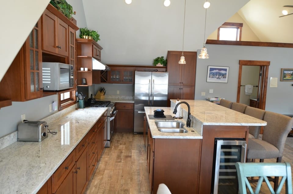 Fully Equipped Kitchen - The fully equipped kitchen has granite countertops and a bar for more seating.