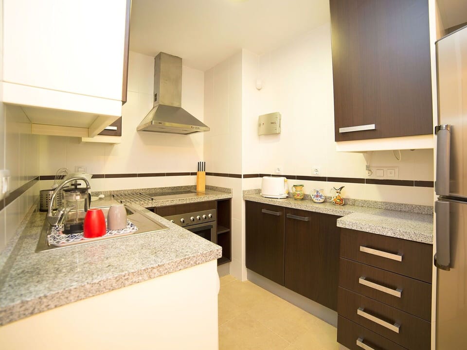 Countertop, Room, Property, Kitchen, Cabinetry, Furniture, Interior Design, Kitchen Stove, Building, Yellow