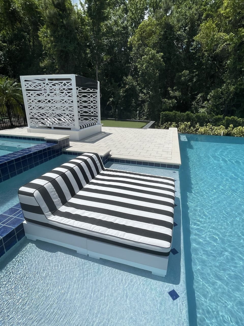 Hang out in the water on the daybed then slide into the pool to cool off!