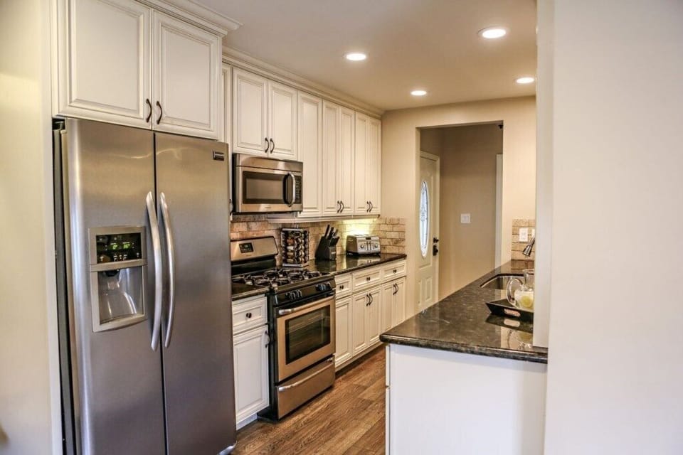 Open Concept Custom Kitchen with Stainless Steel Appliances