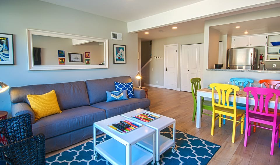- Spacious living room with modern sofa bright decor and easy dining access   - Dining area connects smoothly to kitchen for enjoyable guest experiences   - Airbnb keywords highlight open plan living and modern vacation rental