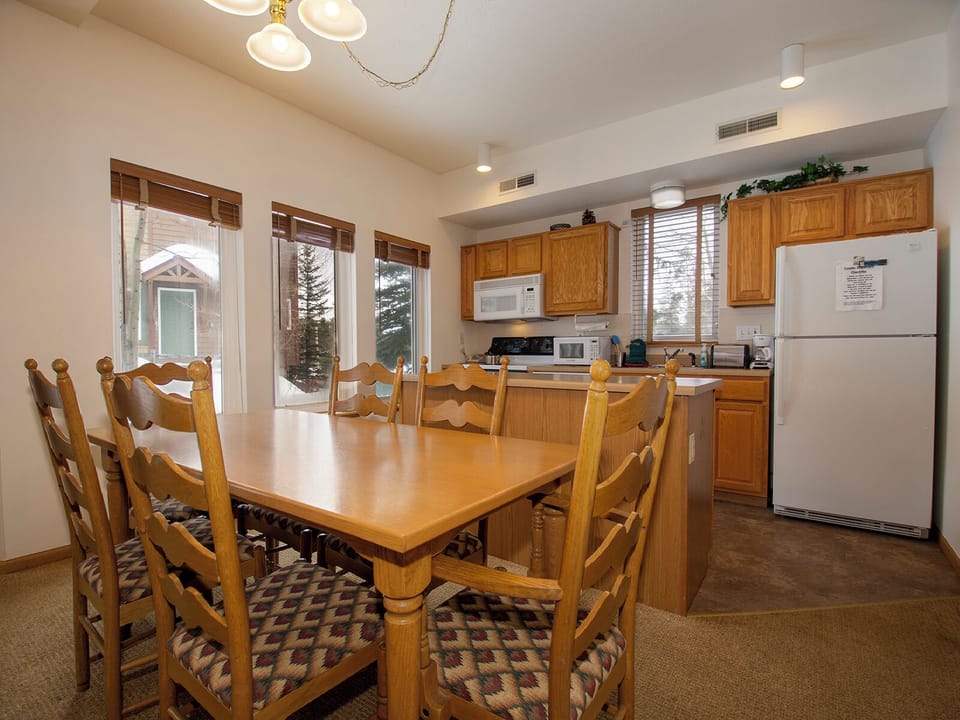 Gather your group around this spacious dining table where shared meals and conversations flow naturally into the fully-equipped kitchen.