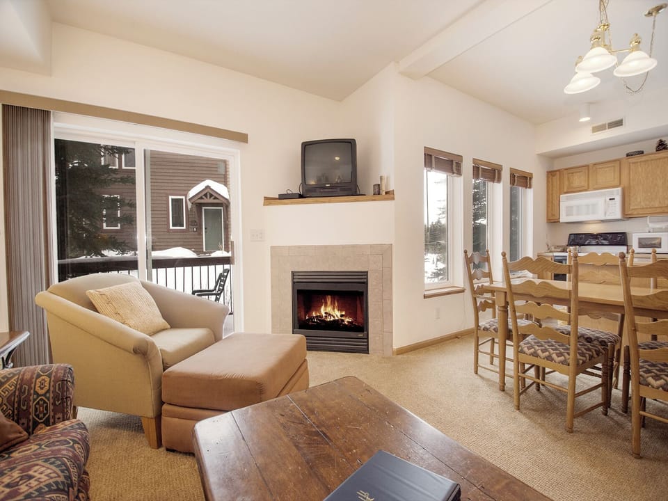 Cozy up by your private fireplace while snowflakes dance outside. This warm living space blends comfort with mountain charm perfectly.