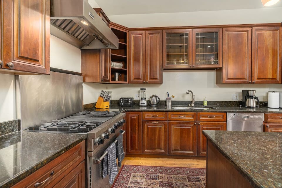kitchen with oven, stove, and sink