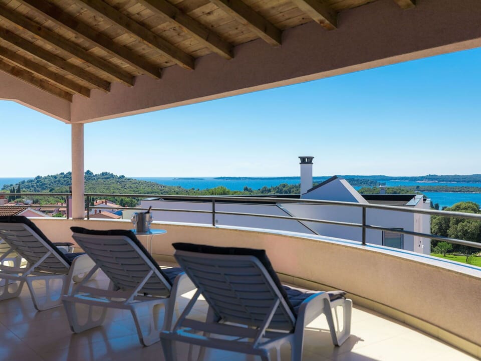 Sky, Property, Furniture, Water, Shade, Seaside Resort, Table, Outdoor Furniture, Chair, Wood