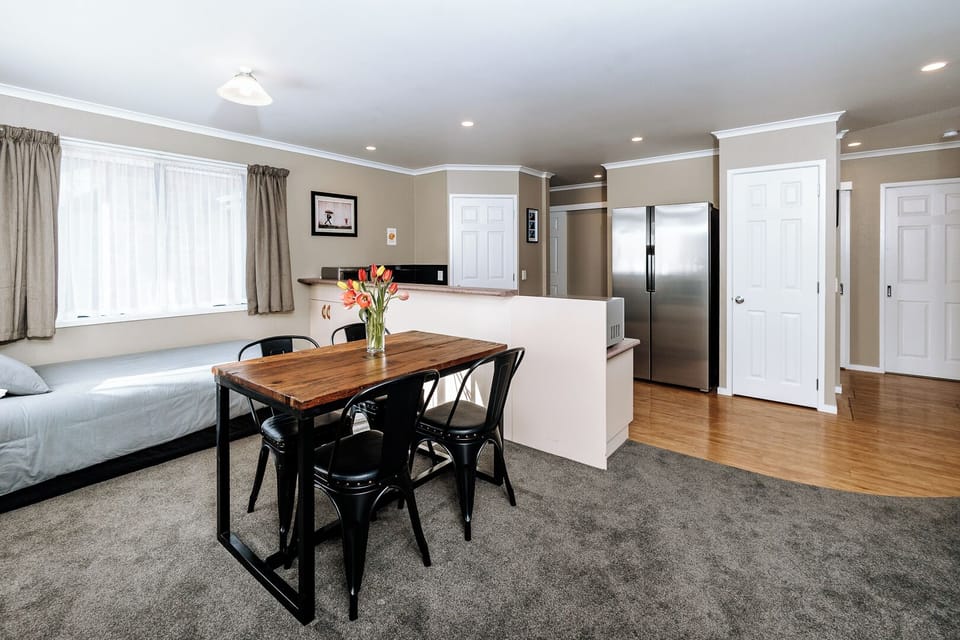 Open-plan diningroom area with 4th bed. Dining table, with 4 chairs (4 shown)