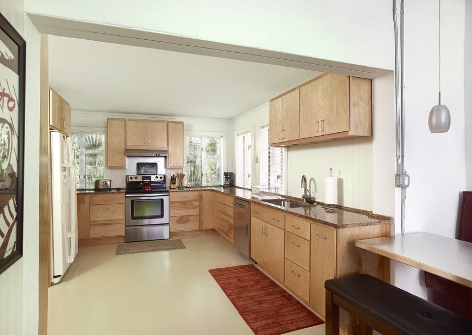 Fully stocked kitchen with updated appliances, custom cabinets and granite counters.