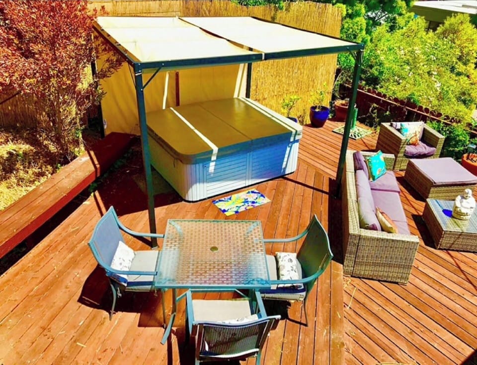 Private yard with large deck, hot tub, outdoor sofa, dining area & bay views!