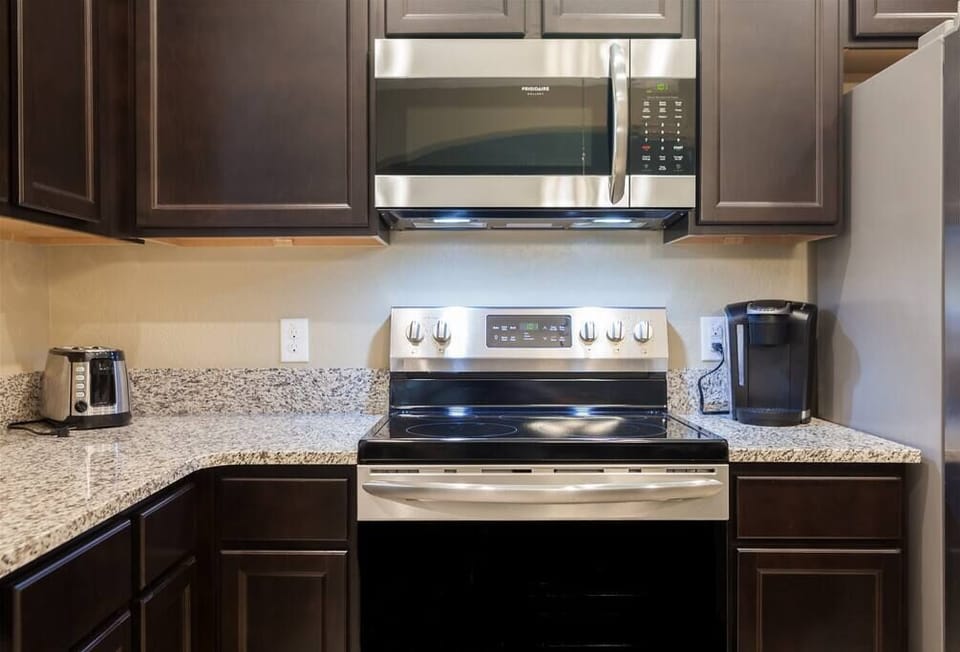 Kitchen w/ Stainless Steel appliances and Granite Countertops