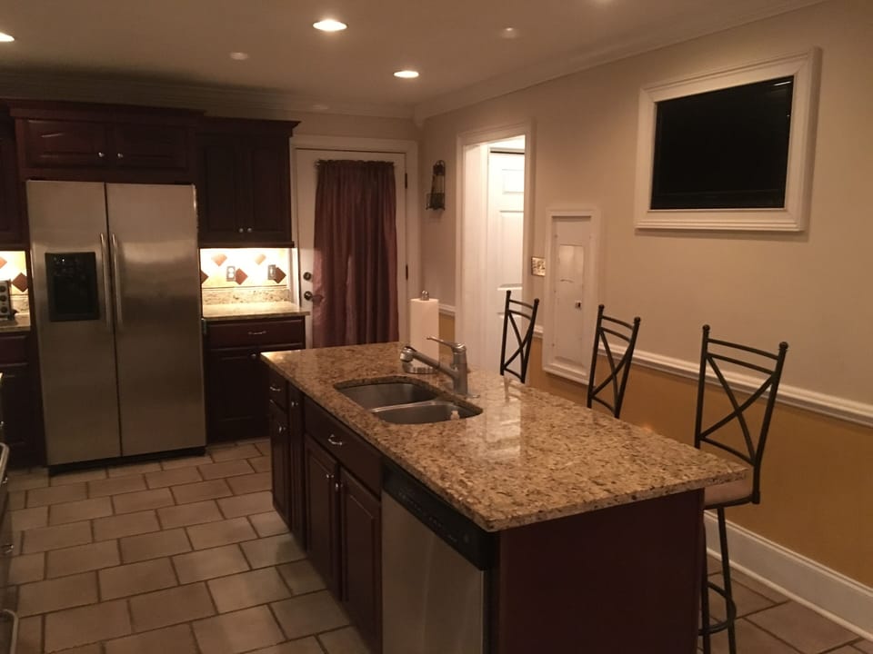 Kitchen with large island and 43” smart TV.