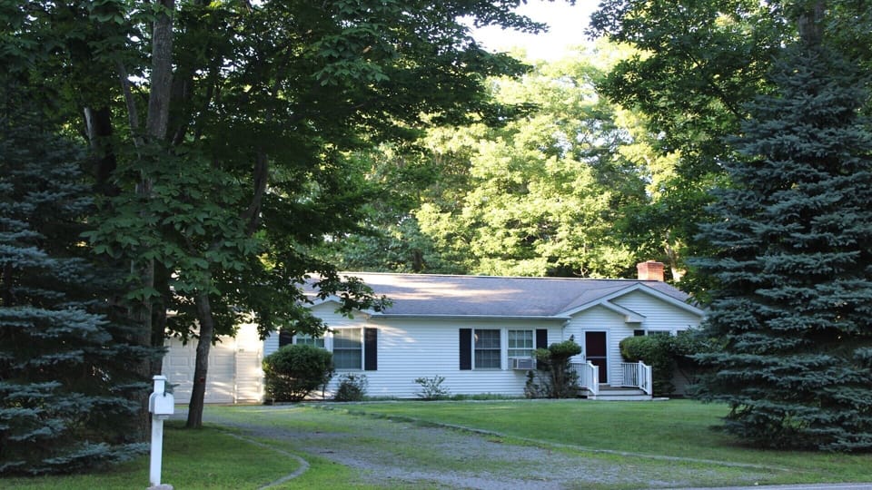Long driveway and parking area for multiple cars. 