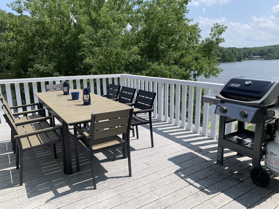 Deck off the main level with seating for 8 and a Weber gas grill.