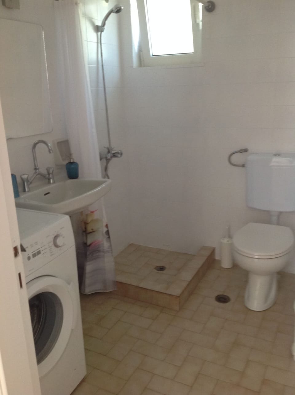 shower room with w.c. and hand basin. The washing machine is located here