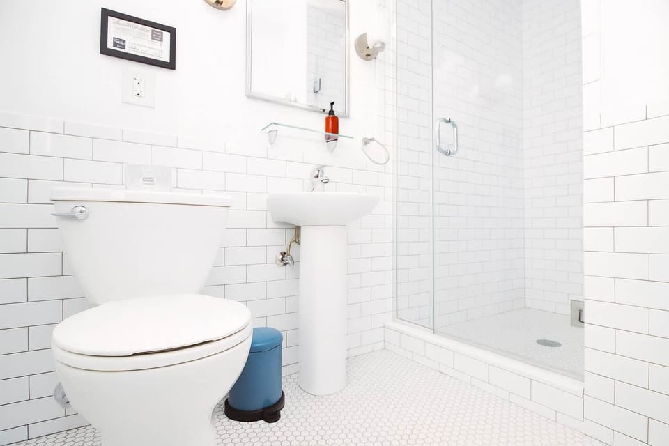 Spotless white bathroom with subway tile, glass shower, and modern fixtures—bright, fresh, and thoughtfully designed for comfort.
