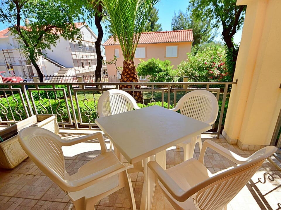 Furniture, Plant, Property, Chair, Building, Sky, Outdoor Furniture, Shade, Wood, Armrest