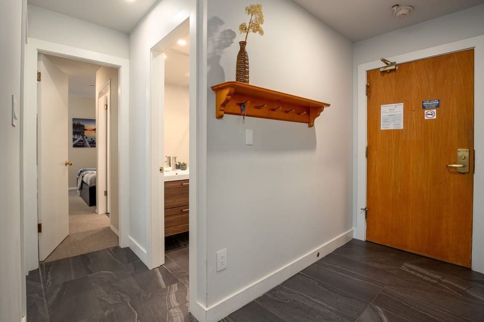 The tiled entryway includes hooks and cubbies for organizing gear and coats.