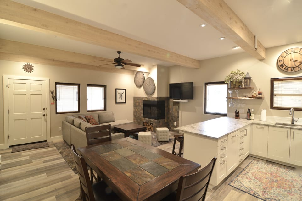 Spacious main room with IKEA kitchen, cozy gas fireplace and comfortable couch.
