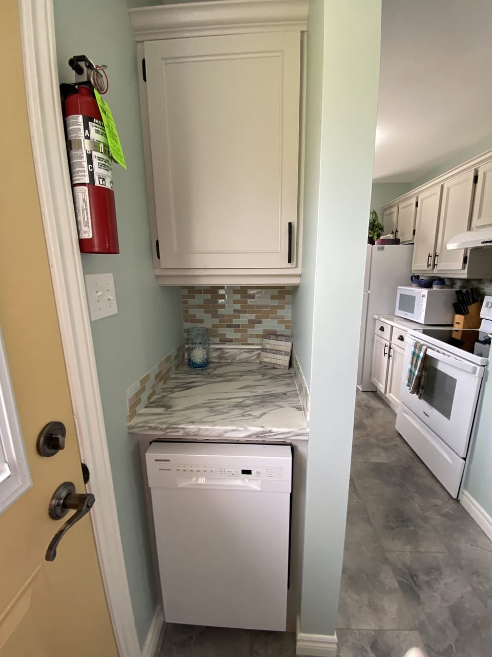 A new dishwasher and another cupboard to hold items for BBQing etc.