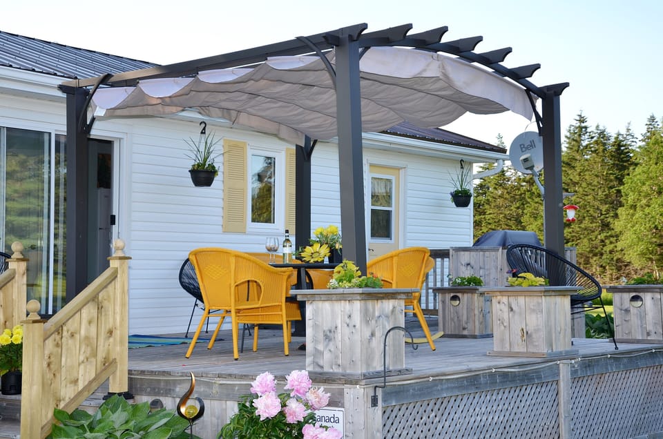 Front deck with the pergola and the tarp pulled over to offer shade.