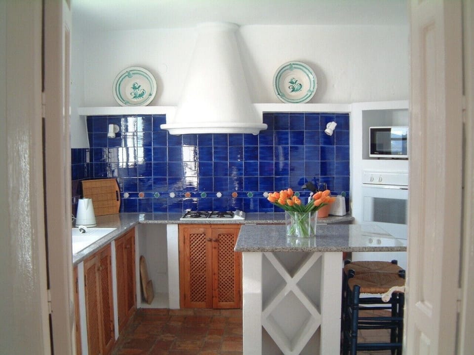 The kitchen features hand made tiles