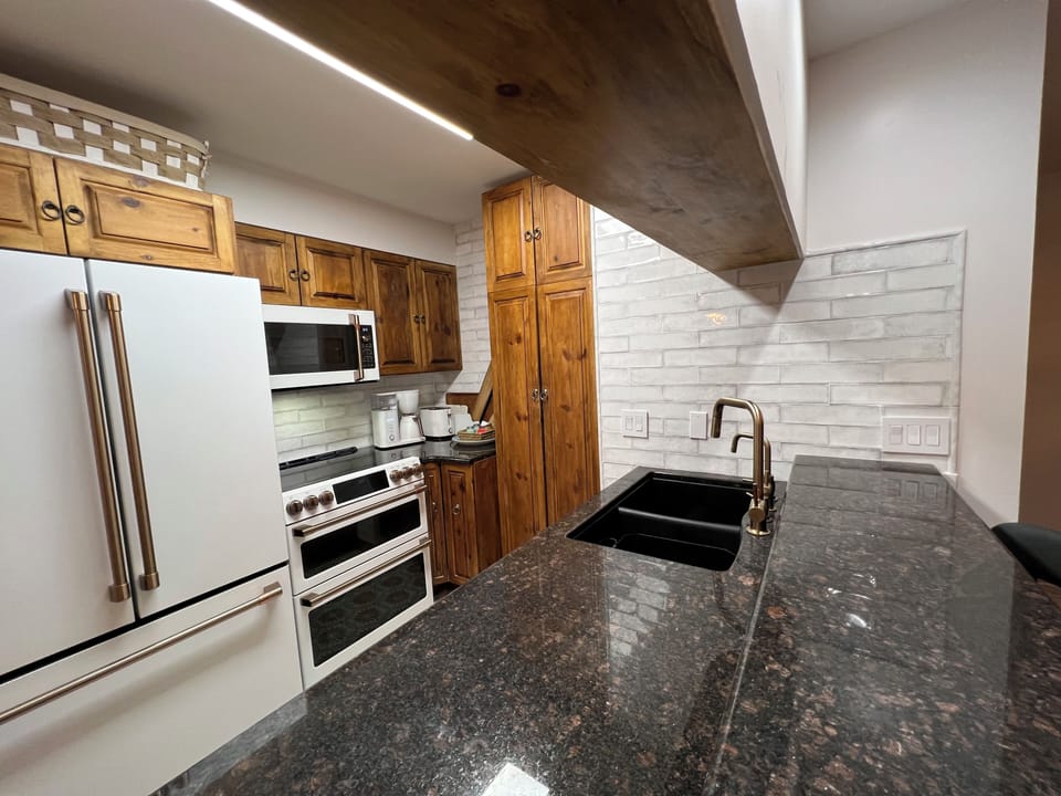 Kitchen has new appliance including a dual oven and a microwave.