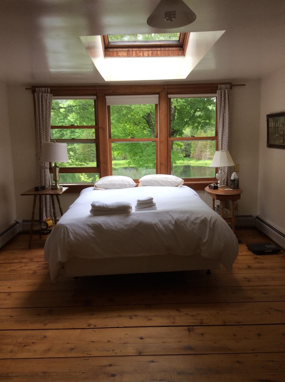 Master bedroom with three  pond view windows, Velux skylight above queen bed.