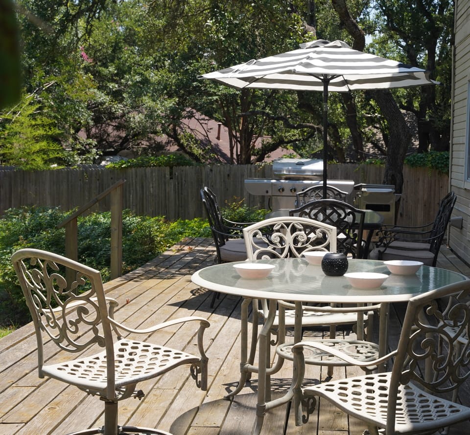 Enjoy seating for 10, a  Weber charcoal grill and serving cart on the back deck.