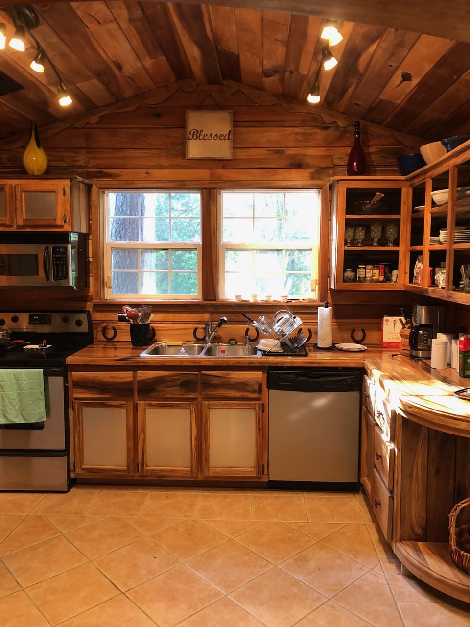 The kitchen is set up with all dishes and utensils, a dishwasher, too.