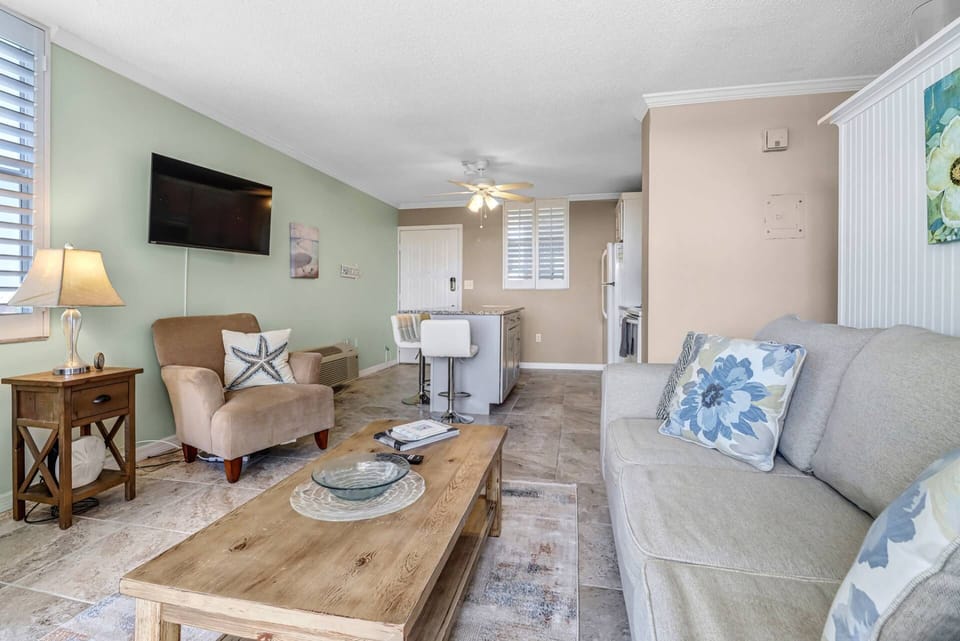 The open concept living area enjoys a view with a slice of the Gulf and its spectacular evening skies.