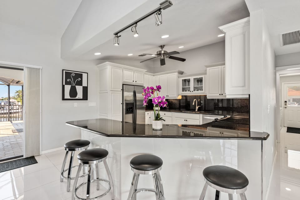 Kitchen features granite counters, stainless appliances, coffee maker and Keurig