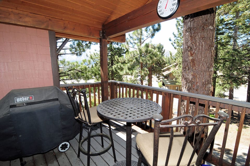 outdoor covered balcony  main level with bbq, seating area for 4, beautiful view