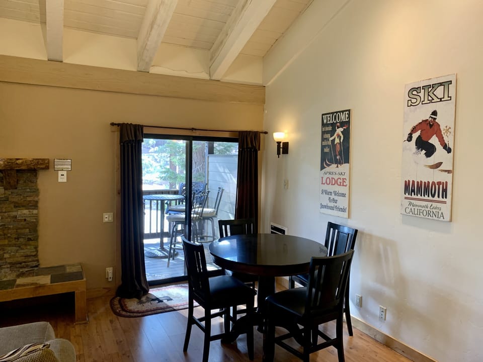 Game table in living room, balcony with bistro table seating for 4, propane bbq