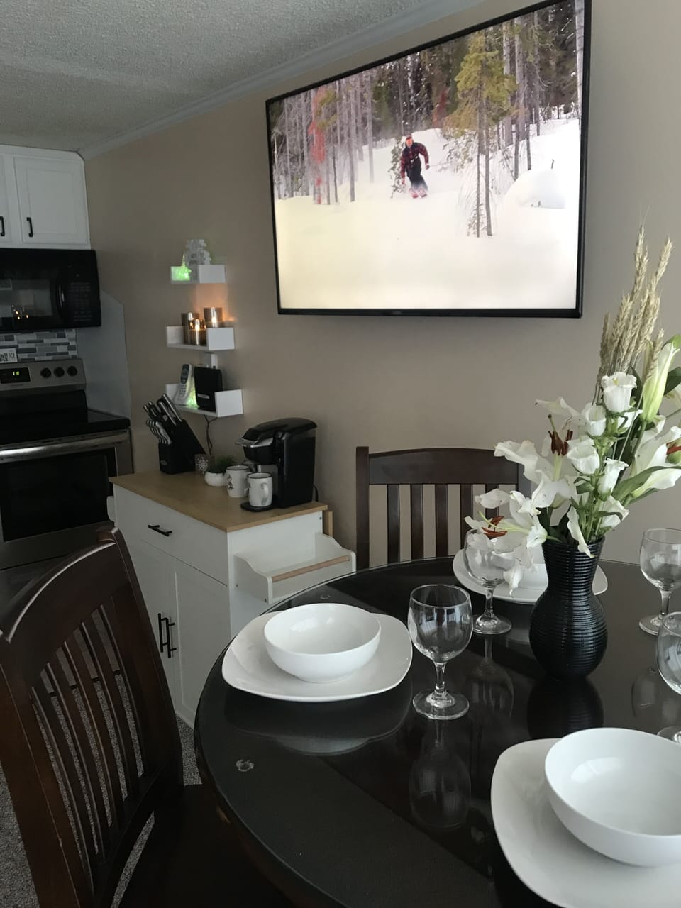 Dining table with 55" TV in background.