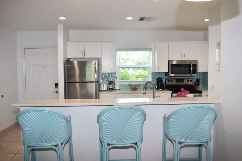 Breakfast bar and bright LED pot lights in kitchen