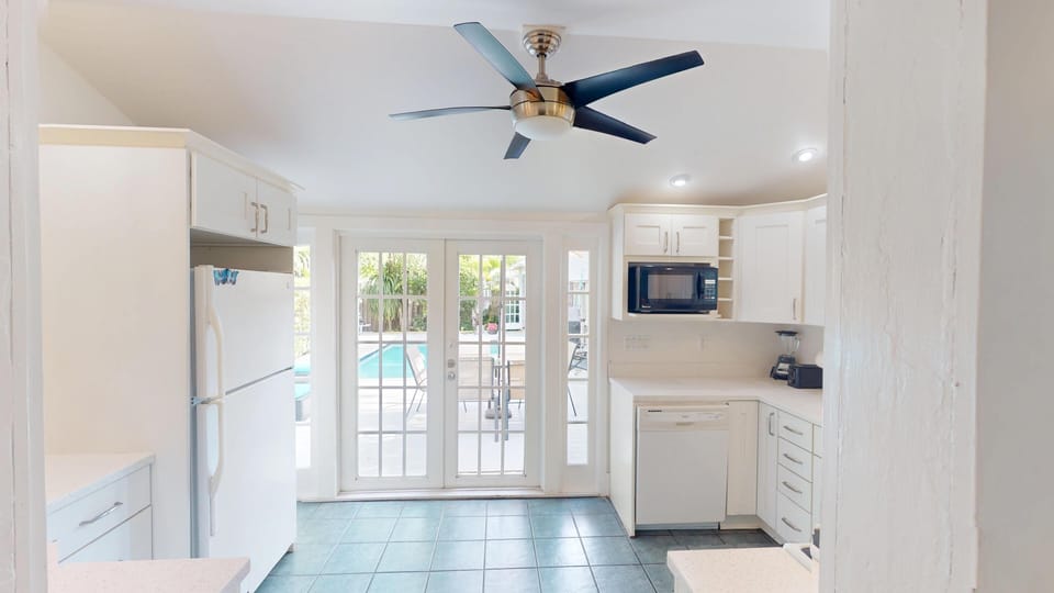 Doors lead out to the back patio and pool