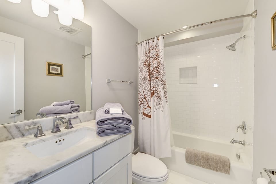 With its marble counter tops and tiled shower, the bath is an oasis.
