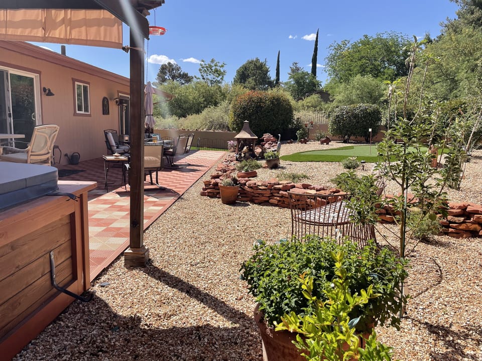 Covered hot tub, fruit trees and flowering shrubs