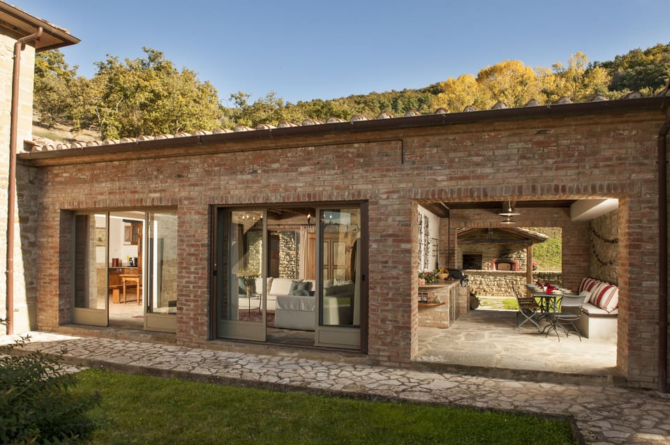 View of the (L-R) kitchen, Living Room and Pergola - with pizza oven at back. 
