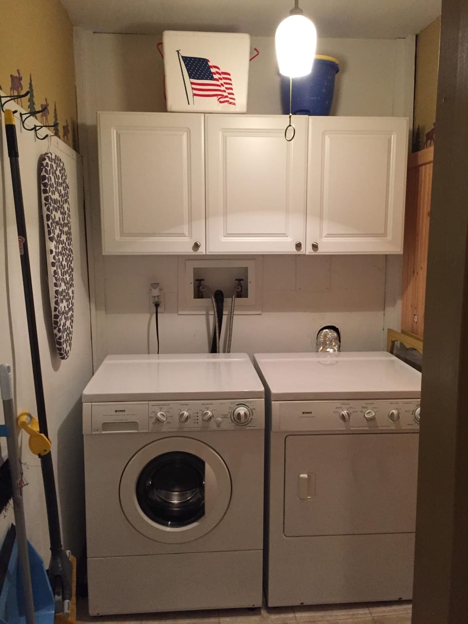 Washer and dryer, iron & small ironing board,  plus supplies in laundry area
