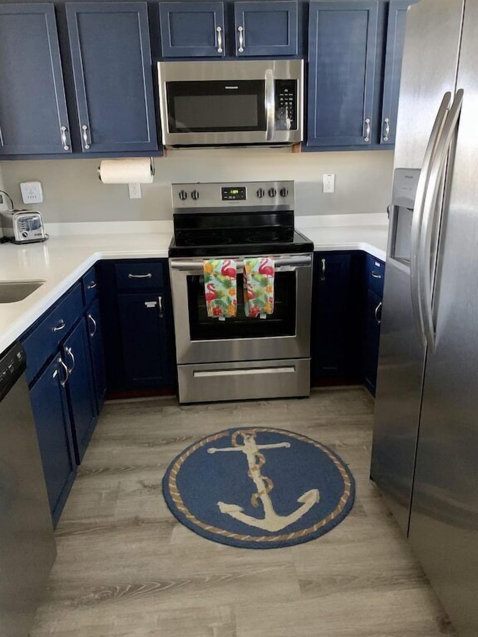 Coastal kitchen with keurig, toaster, blender, crock pot and coffee pot.  