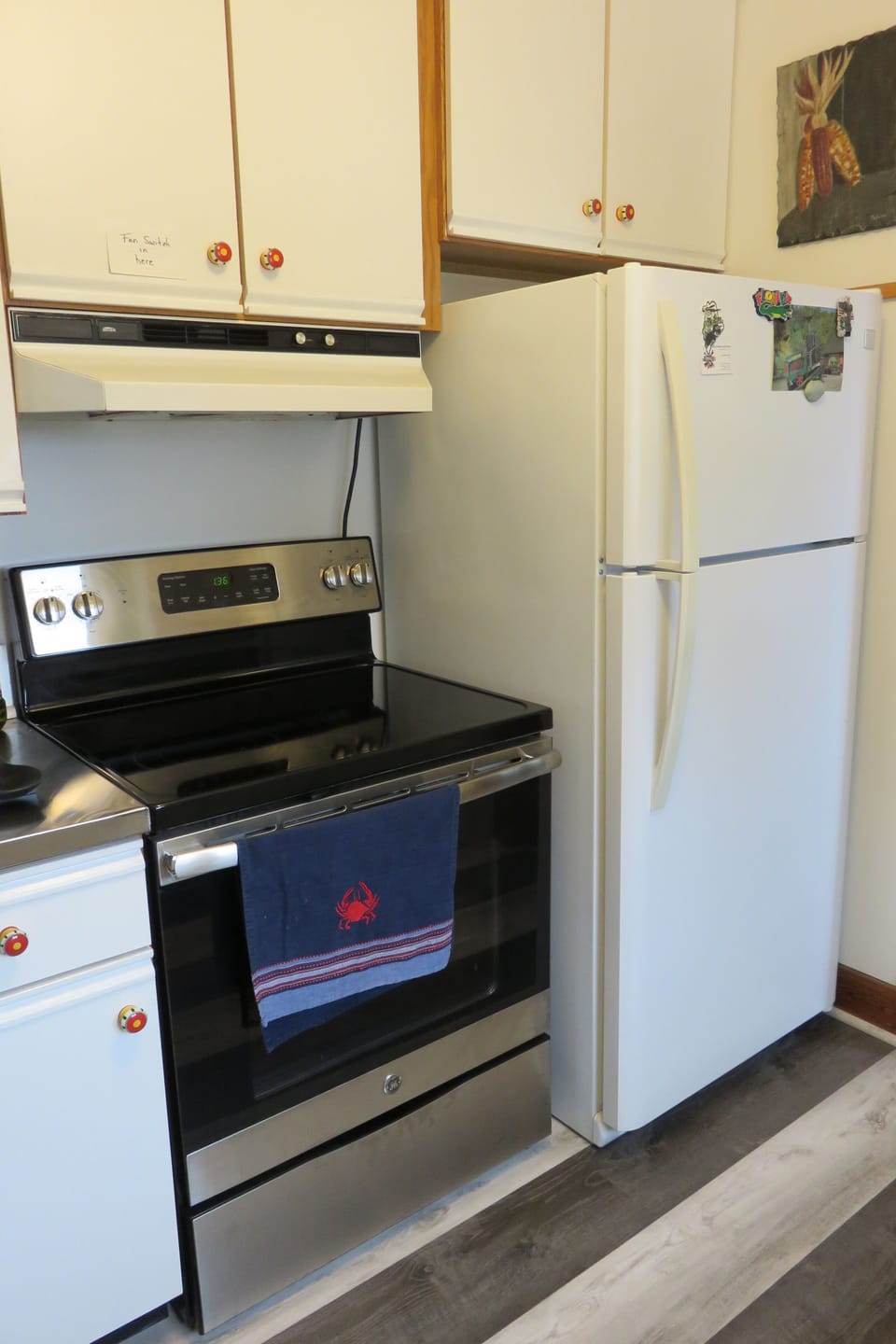 Kitchen with 30" glass top self-cleaning range and refrigerator
