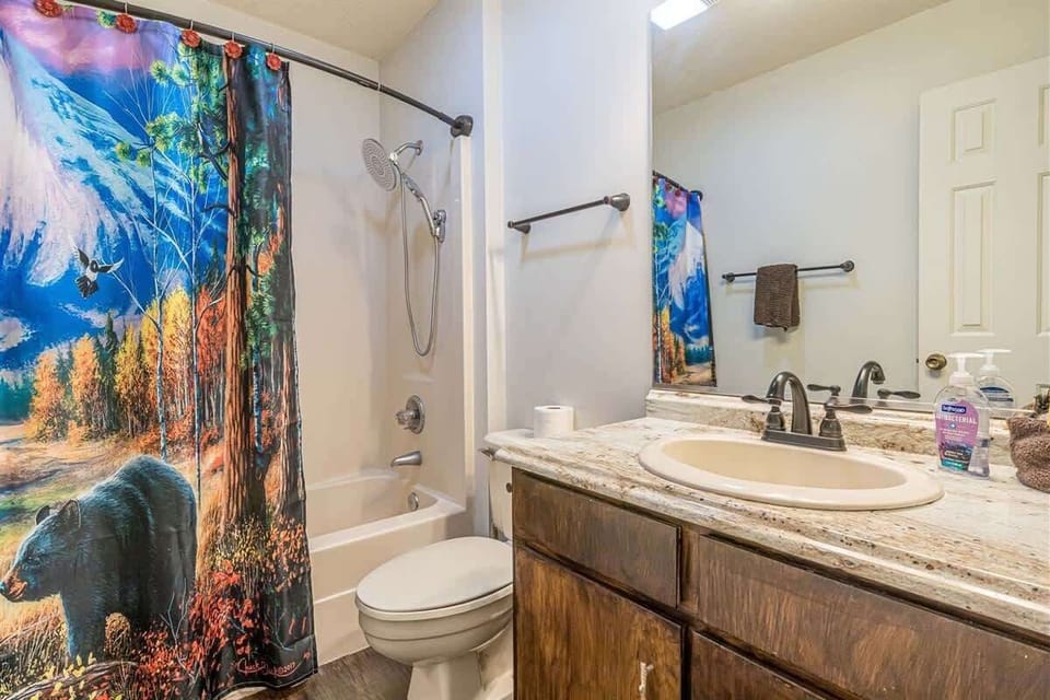 Freshen up in this inviting bathroom, featuring rustic details and a fun nature-inspired touch.
