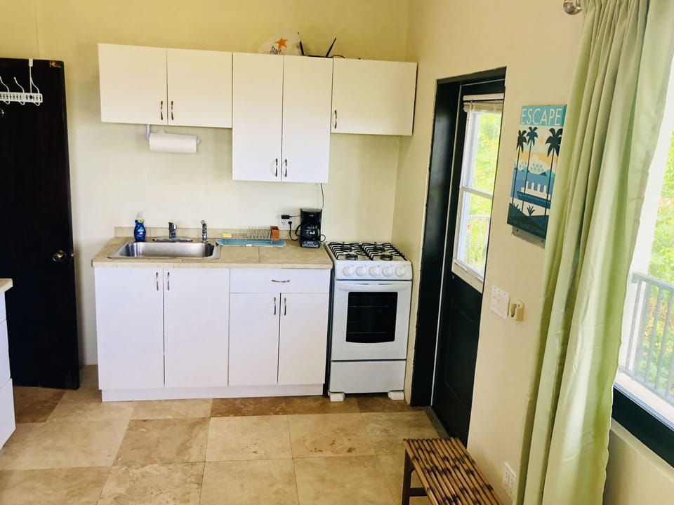 Entrance door on right, small kitchen, bathroom door on left