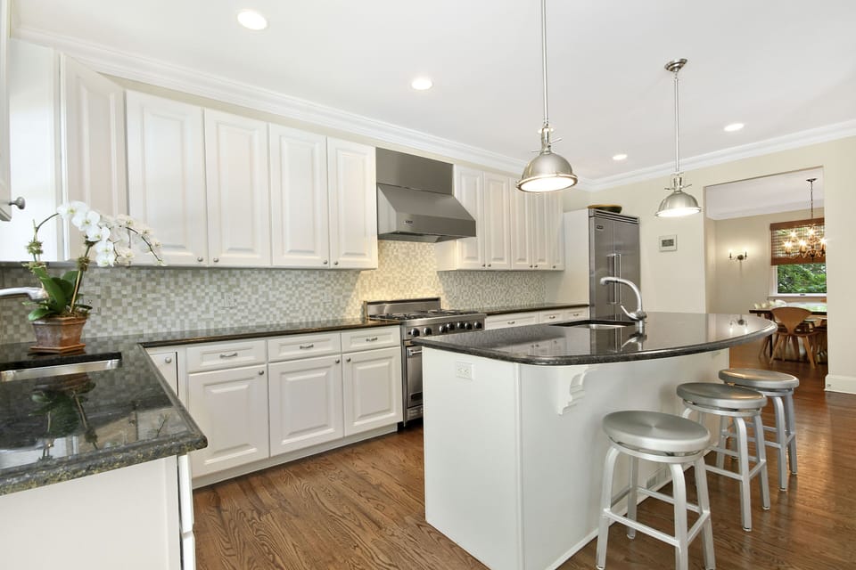 White Kitchen With Viking Range, Viking Refrigerator, and Two Bosch Dishwashers