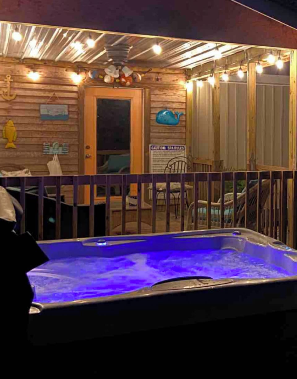 Hot tub by covered deck and gameroom