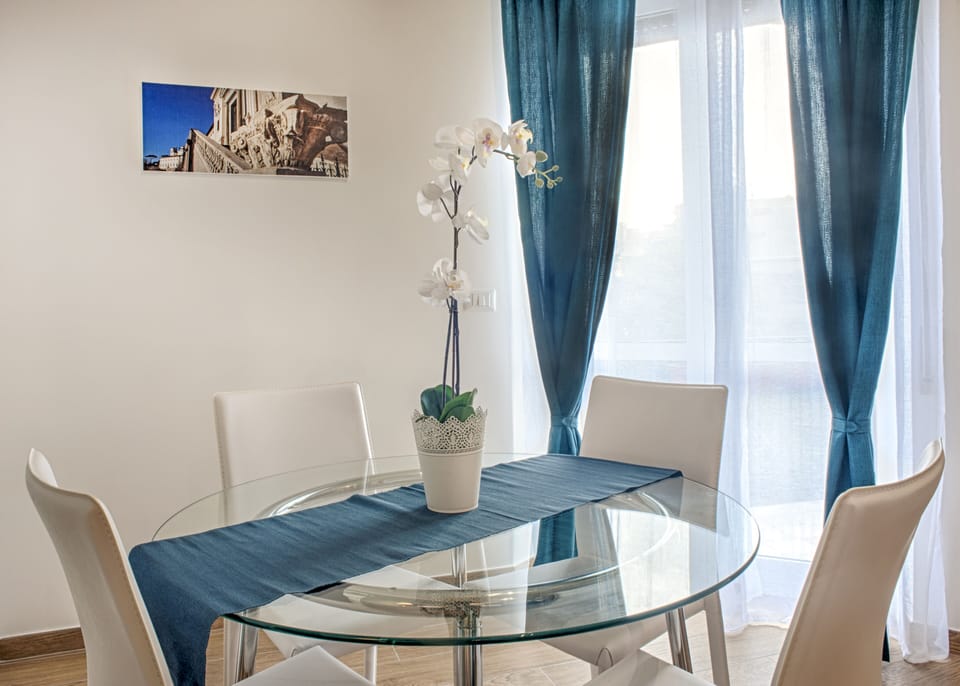 table and chairs in front of the balcony