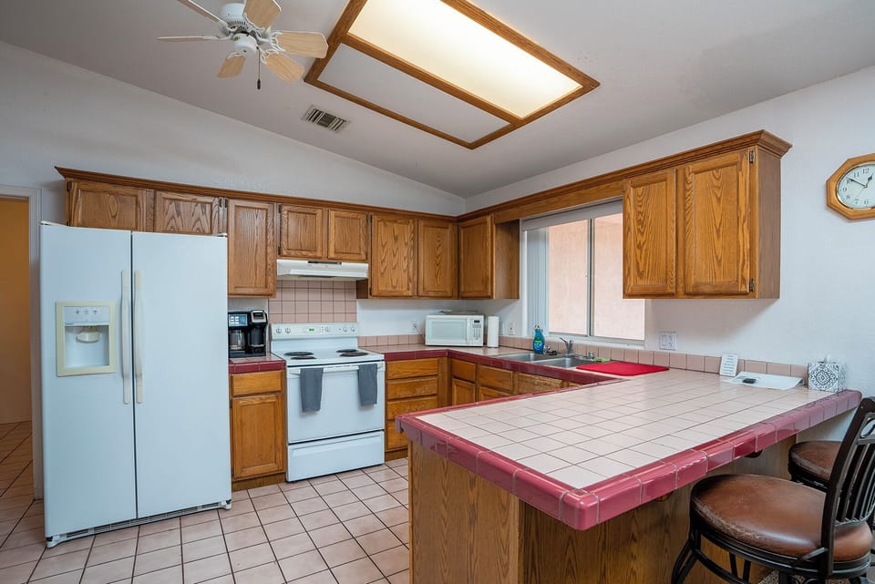 Convenient open kitchen with all the amenities... includes breakfast bar, chairs