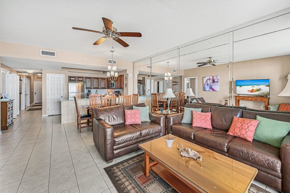 Living area, dining area, kitchen and hallway.
