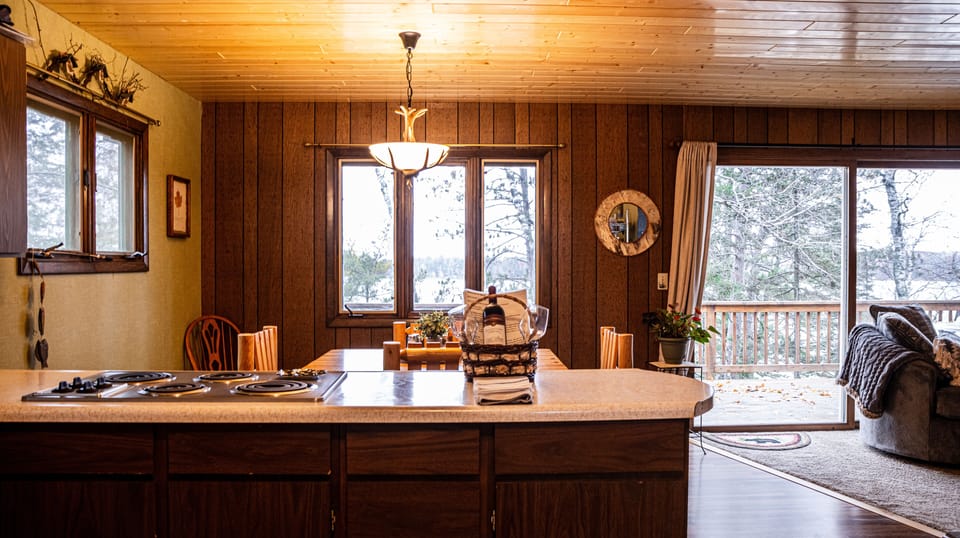 Kitchen looking into dining room and deck